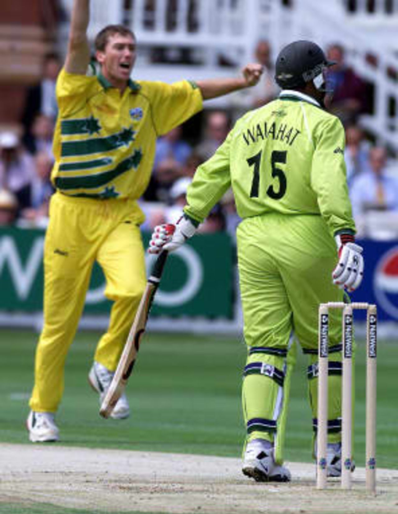 Glenn McGrath (L) of Australia celebrates taking the wicket of Wajahatullah Wasti who was caught by Australian Mark Waugh in the slips during the World Cup Cricket Final against Pakistan 20 June 1999 at Lords in London