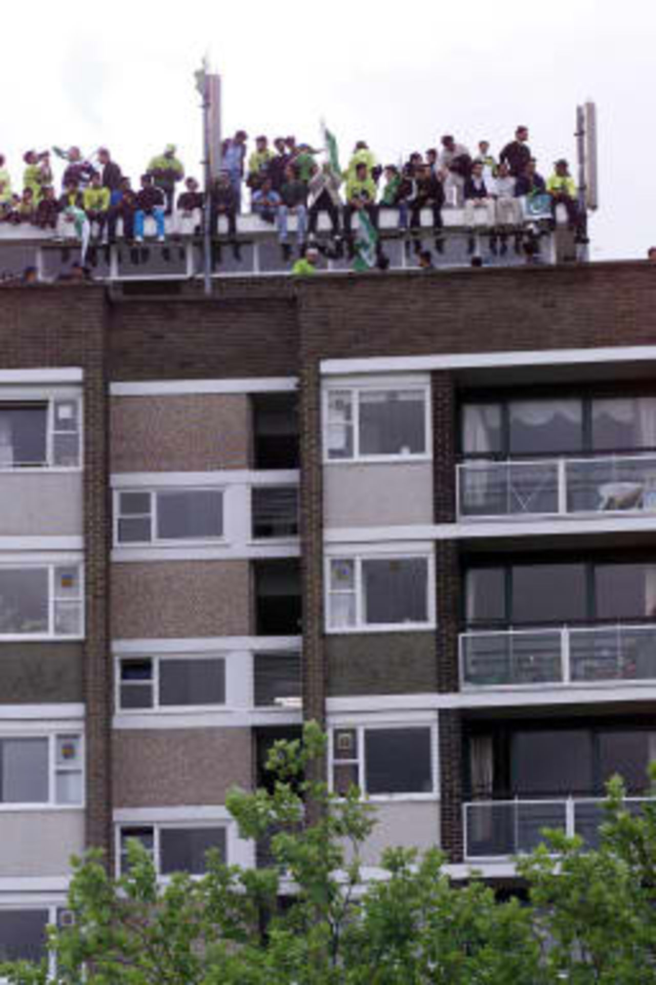Pakistan fans watching  the World Cup Cricket Final between Australia and Pakistan from an overlooking block of flats , Sunday June 20,1999 , at Lords, London