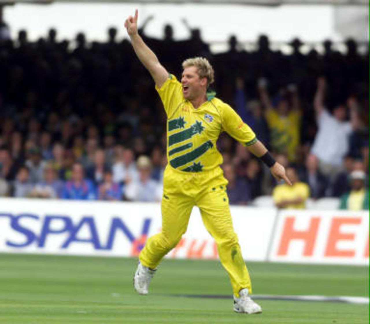 Australia's Shane Warne runs towards his captain Steve Waugh after taking his fourth wicket that of Pakistan's captain Wasim Akram 20 June 1999 during the Cricket World Cup final at Lord's