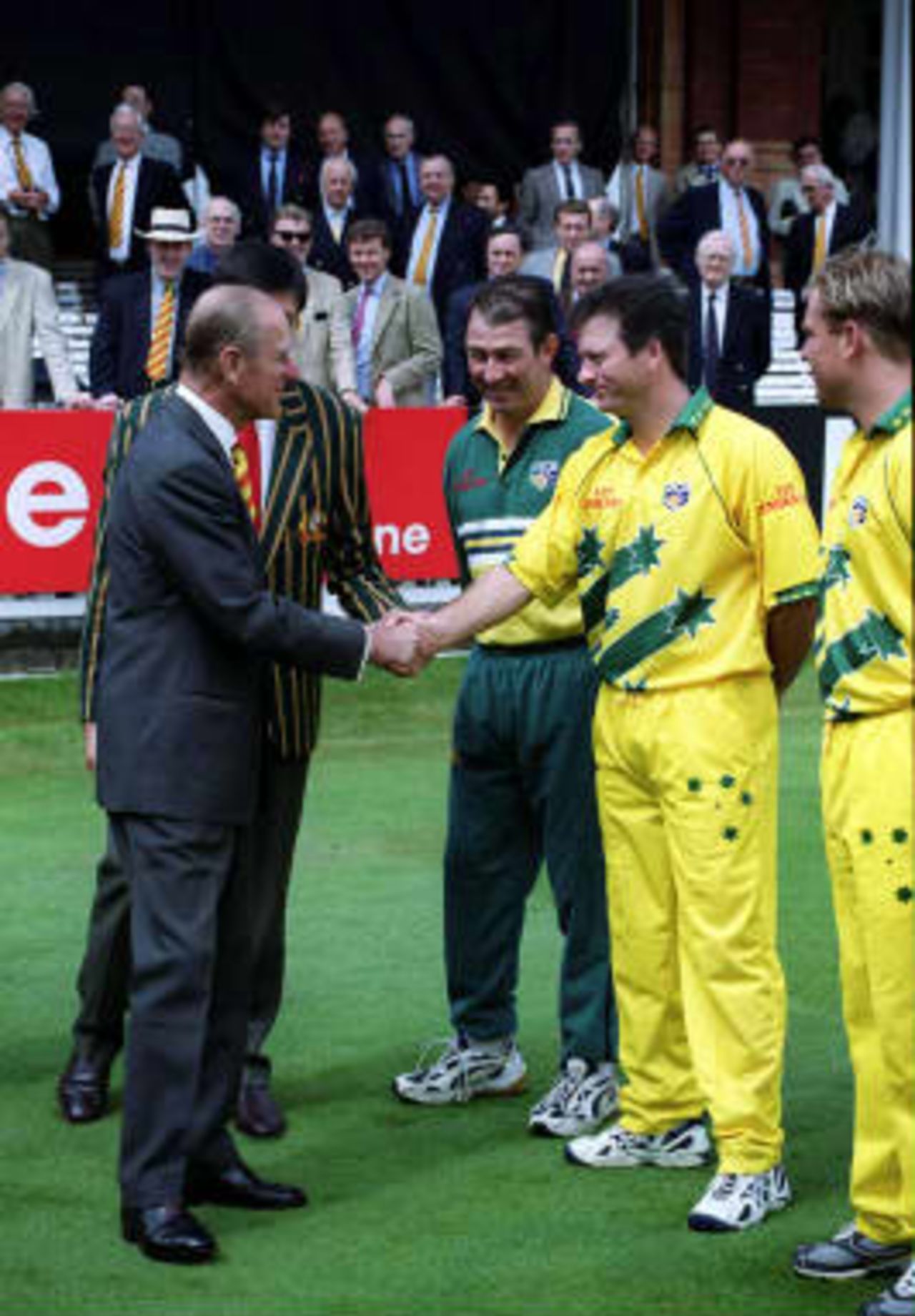Prince Philip (Left), the Duke of Edinburgh, is introduced to the Australian cricket World Cup side captain Steve Waugh before the World Cup final against Pakistan at Lords as Australian coach Jeff Marsh (Center) and Shane Warne (Right) look, 20 June 1999.