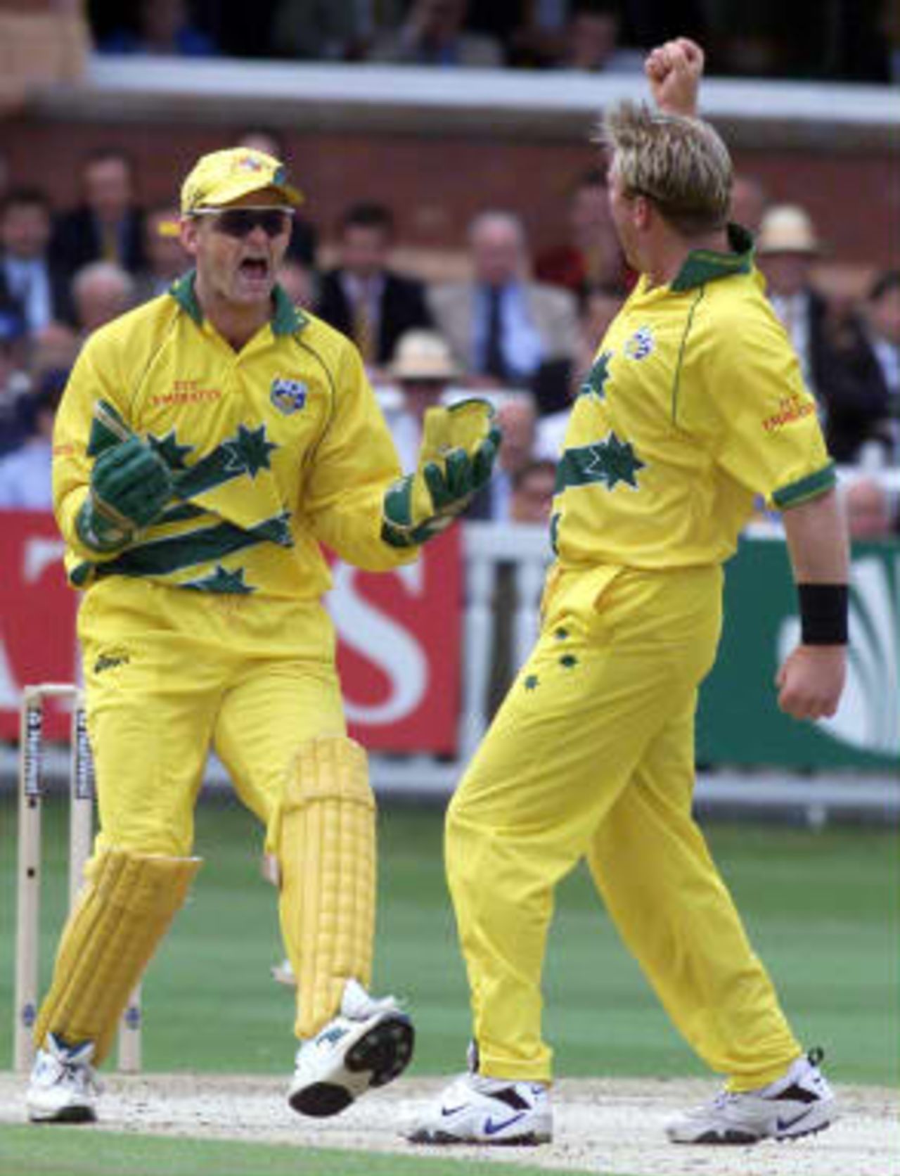 Australia`s Shane Warne celebrates with keeper Adam Gilchrist after he had taken another Pakistan wicket in the World Cup cricket Final at Lord`s, London, Sunday 20 June 1999.