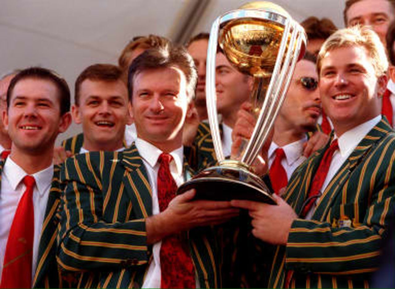 Australian cricket captain Steve Waugh (3rd Left) and vice captain Shane Warne(Right) hold the World Cup trophy surrounded by the rest of the team in Sydney on 28th June 1999. The team was feted by some 100,000 people during a parade through the streets of Sydney to mark their World Cup win earlier this month.