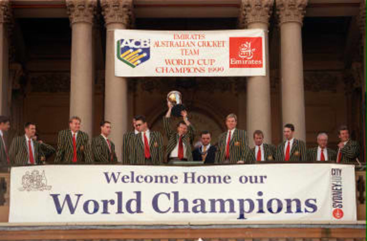 Australian cricket captain Steve Waugh (Center) raises the World Cup trophy surrounded by his teammates and Sydney lord-mayor Frank Sartor (6th Right) on 28th June 1999. The team was feted by some 100,000 people during a parade through the streets of Sydney to mark their World Cup win in England earlier this month.