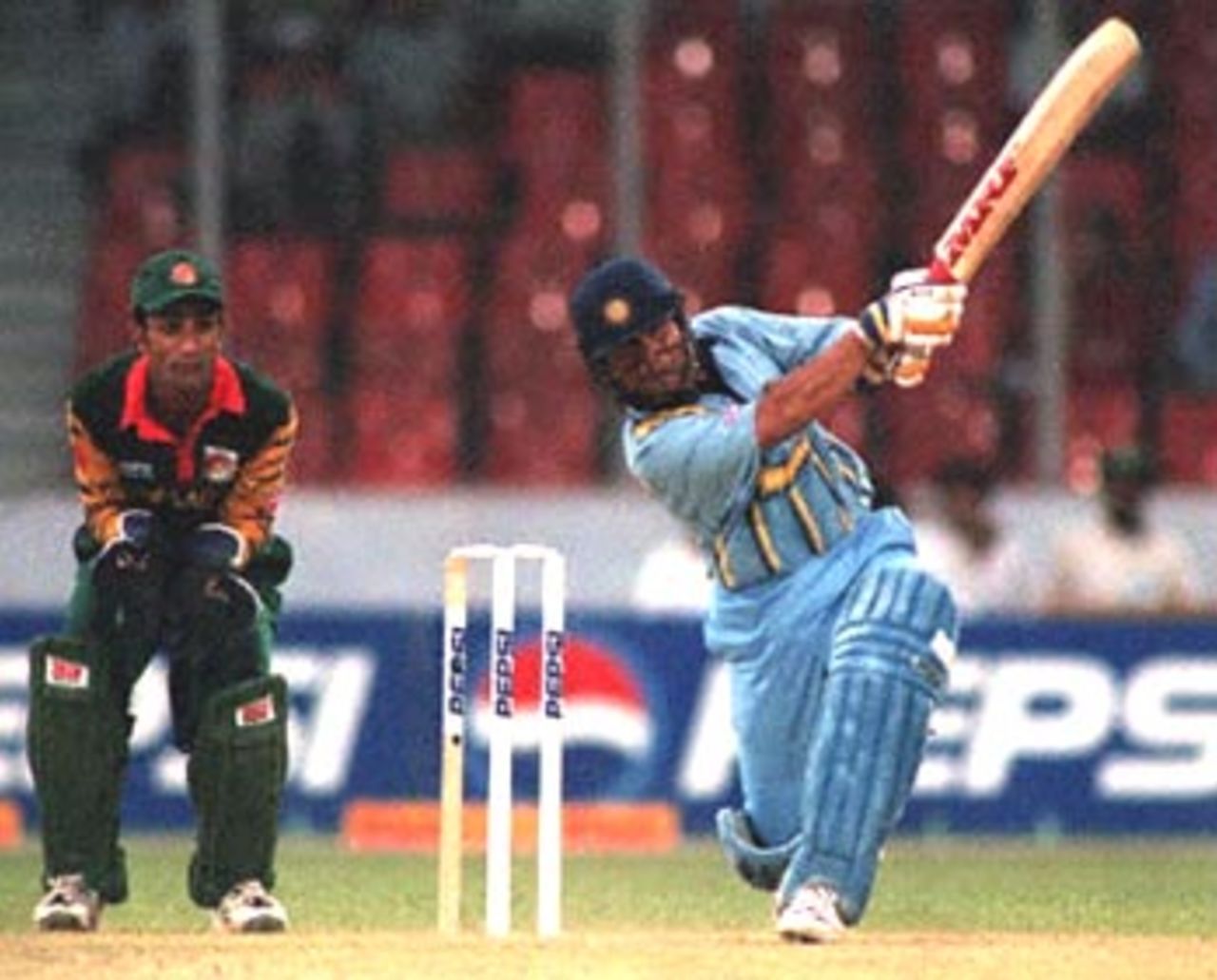 Indian batsman Sachin Tendulkar (R) strikes a ball during his knock of 36 off 25 balls against Bangladesh in the four-nation Asia Cup limited-overs tournament at the Bangabandhu national stadium in Dhaka as Bangladesh's wicket-keeper Khaled Mashud looks on. India won by eight wickets. Sri Lanka and Pakistan are the other teams in the tournament to determine the regional one-day champions. Asia Cup 1999/00, 2nd Match, Bangladesh v India, Bangabandhu National Stadium, Dhaka.30-31 May 2000.