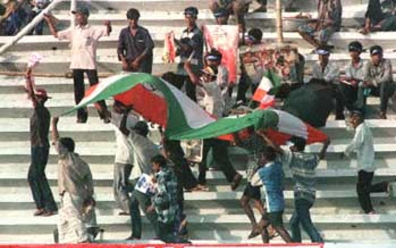 Young Indian supporters at the gallary carry an Indian national flag to give boost to their favourite team during the four-nation Asia Cup limited-overs tournament against defending champions Sri Lanka at the Bangabandhu national stadium in Dhaka. India restricted Sri Lanka 276-8. Asia Cup, 1999/00, 3rd Match, India v Sri Lanka, Bangabandhu National Stadium, Dhaka. 1 June 2000.