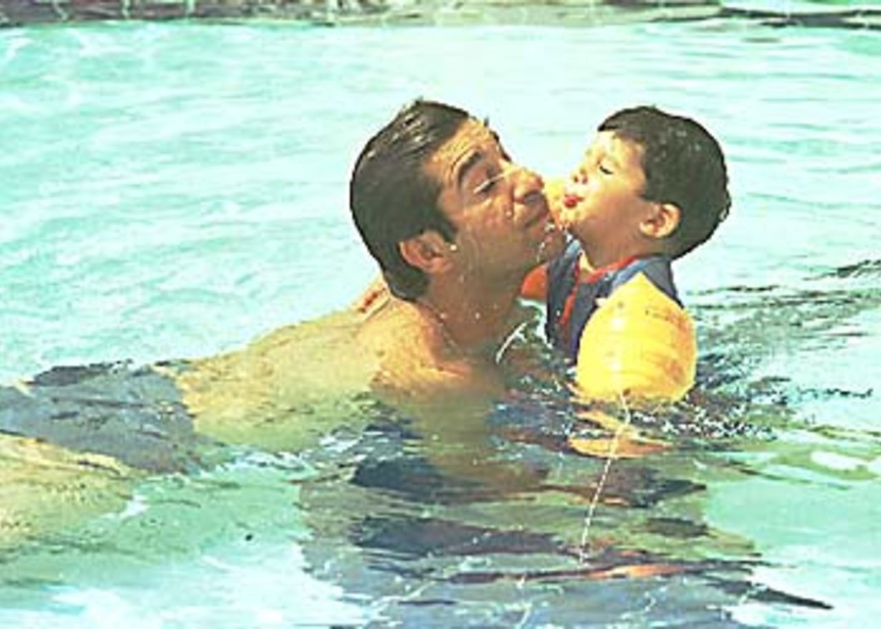 Wasim Akram enjoying a swim with his child, Asia Cup, 1999/00,  Dhaka.