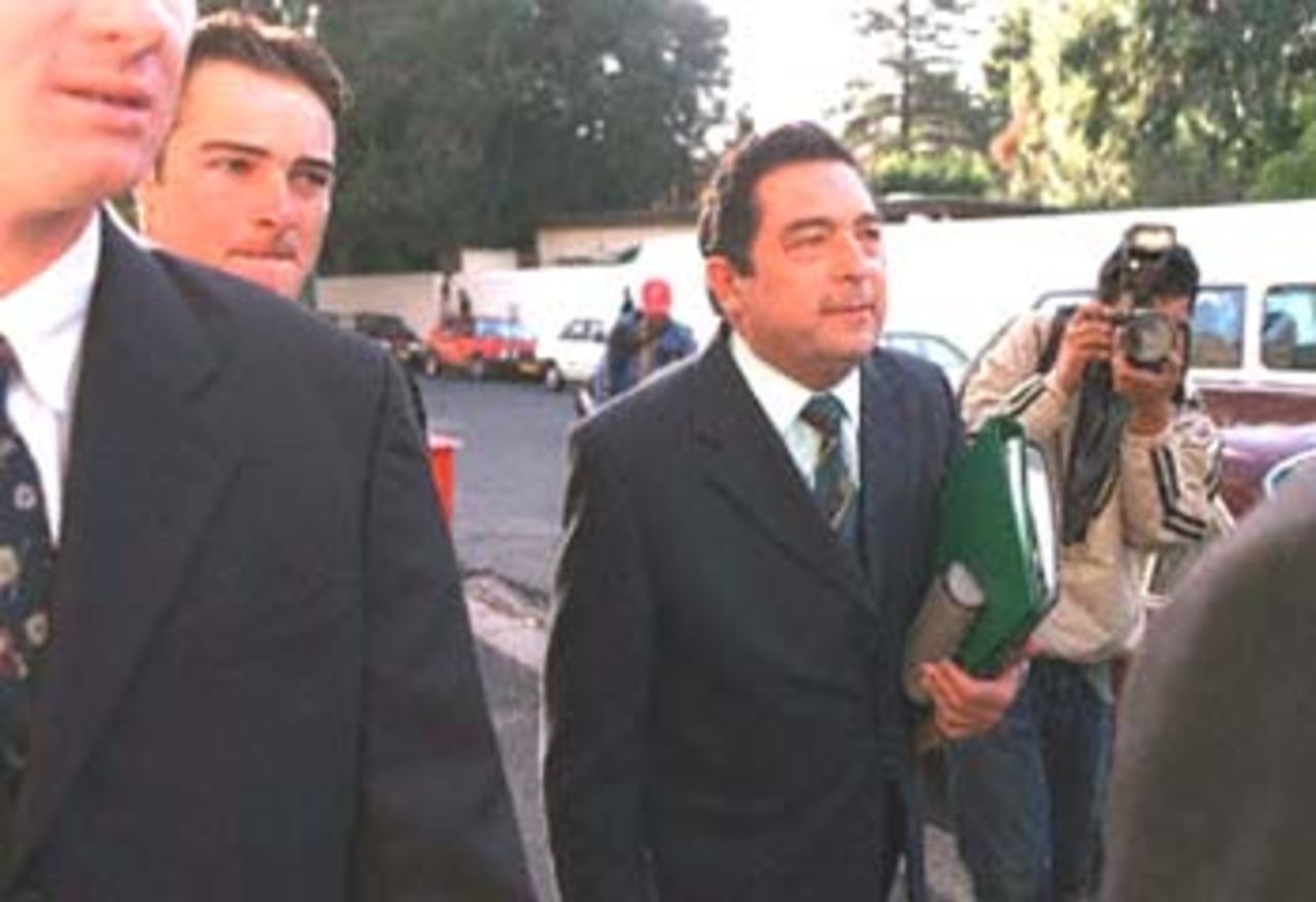 United Cricket Board chief, Ali Bacher (R) arrives at the King Commission Of Inquiry into cricket match-fixing allegations being held in Cape Town 12 June 2000. Cricketer Mark Boucher can be seen on the left.