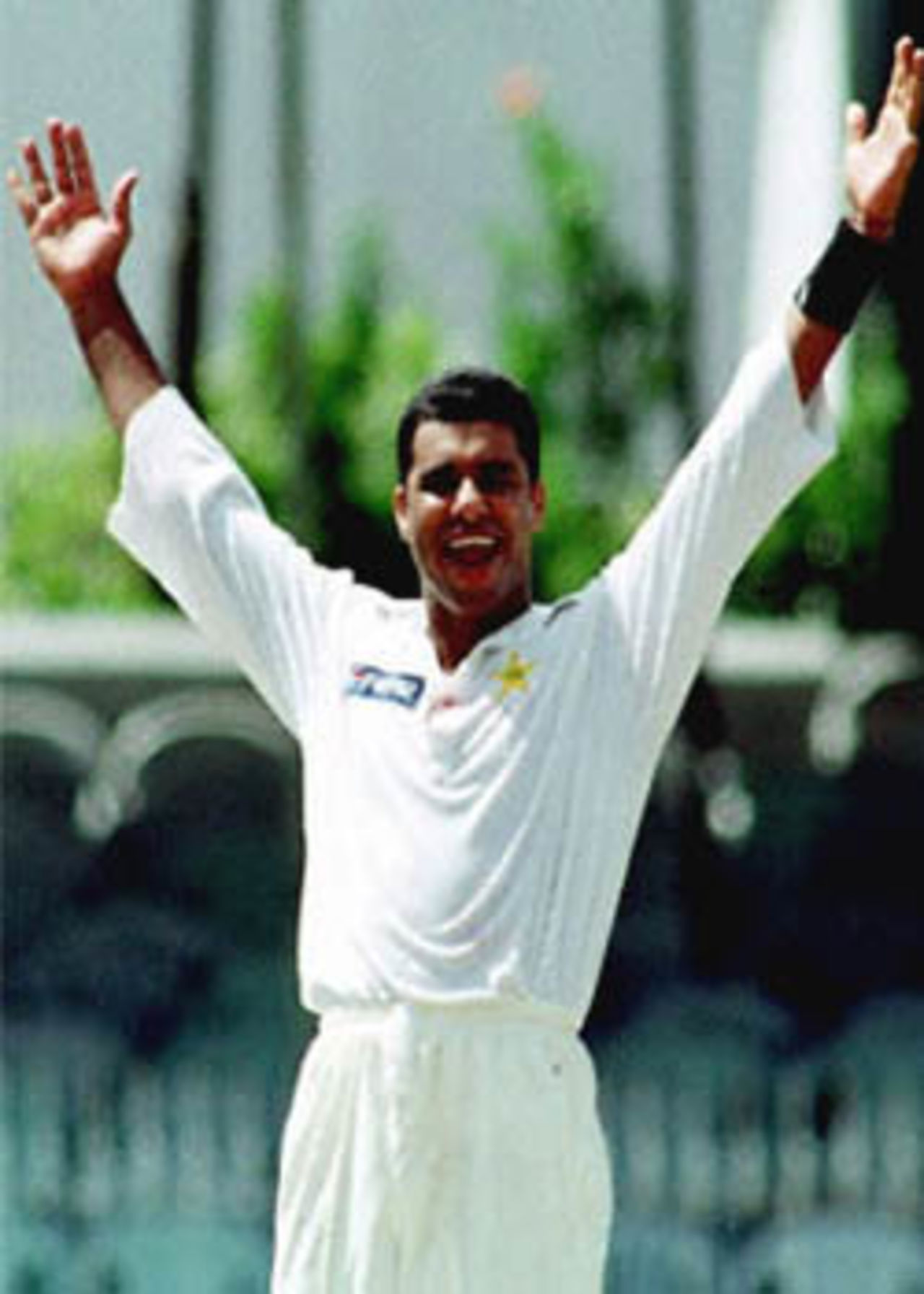 Pakistan bowler Waqar Younis celebrates his 300th Test Wicket after dismissing Sri Lanka's Muttiah Muralitharan. Sri Lanka were all out for 273 on the second day of the first test. Pakistan in Sri Lanka, 1999/00, 1st Test, Sri Lanka v Pakistan, Sinhalese Sports Club Ground, Colombo, 14-18 June 2000 (Day 2).