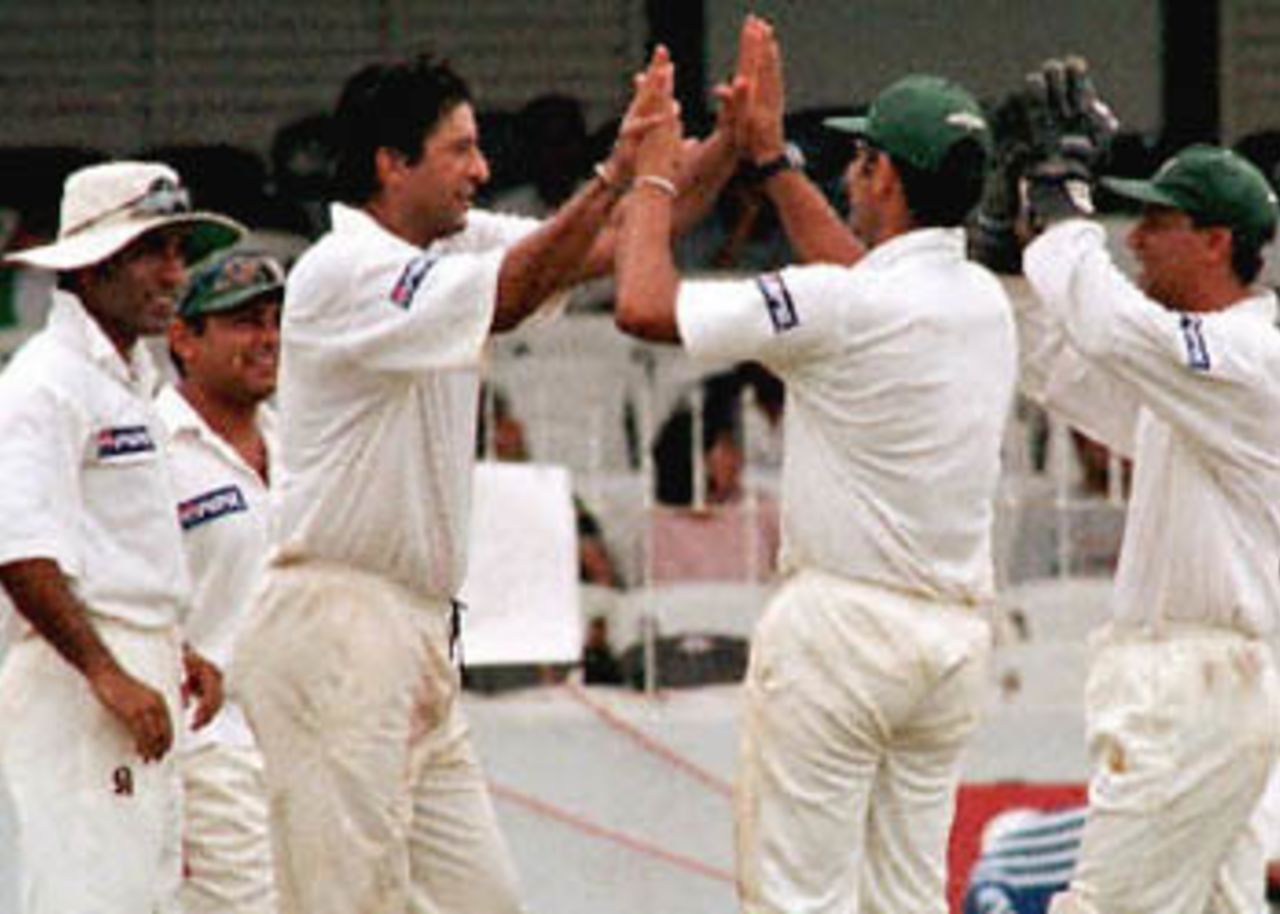 Pakistan's Wasim Akram (3 from L) celebrates with team mates as he dismisses caught and bowled Sri lanka's Chaminda Vaas. Pakistan won by five wickets with a full day's play left and Akram (not in the picture) was named man of the match. Pakistan in Sri Lanka, 1999/00, 1st Test, Sri Lanka v Pakistan, Sinhalese Sports Club Ground, Colombo 14-18 June 2000 (Day 4).