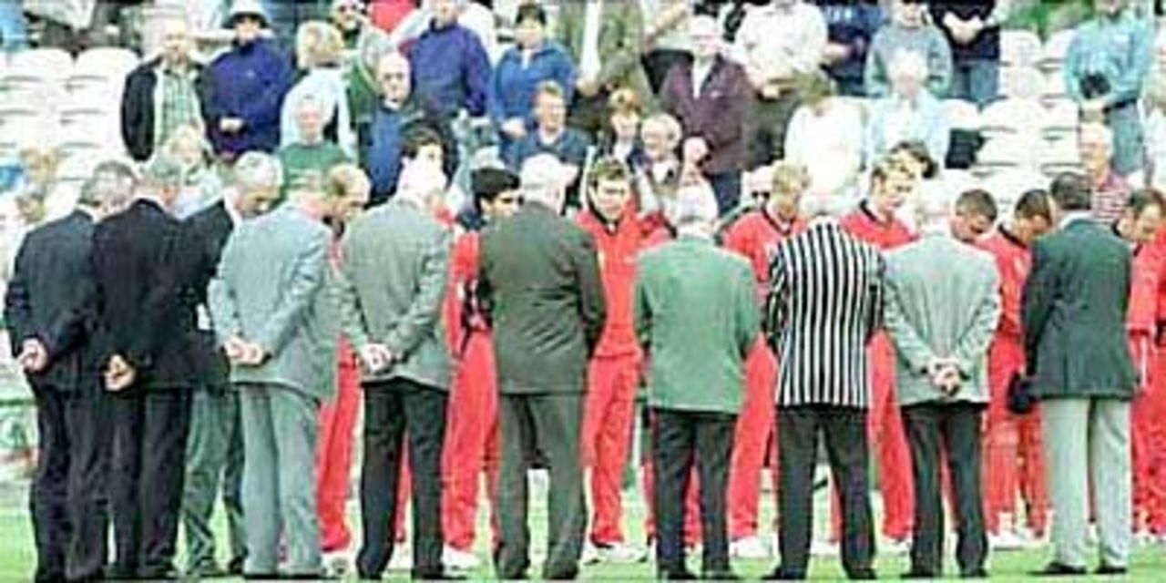 Lancashire players and committee stand as a mark of respect for Brian Statham who died today. National League Division One, 2000, Lancashire v Worcestershire, Old Trafford, Manchester 11 June 2000.