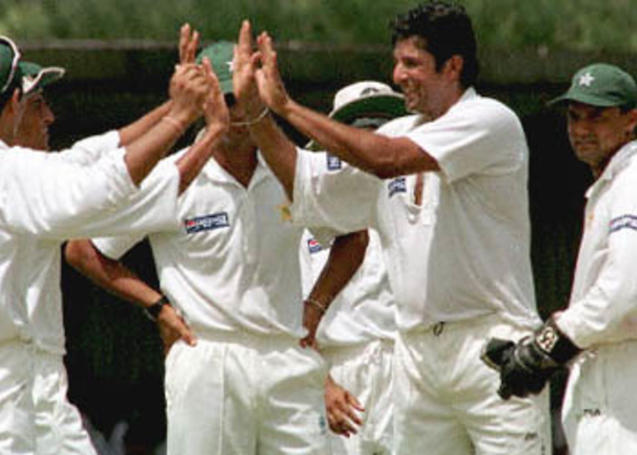 Pakistan fast bowler Wasim Akram (second from right) celebrates the wicket of Sri Lanka captain Sanath Jayasuriya with team mates on the first day of the second cricket Test at Galle International Stadium. Sri Lanka was struggling at 67 for four wickets at lunch. Pakistan in Sri Lanka, 1999/00, 2nd Test, Sri Lanka v Pakistan, Galle International Stadium, 21-25 June 2000 (Day 1).