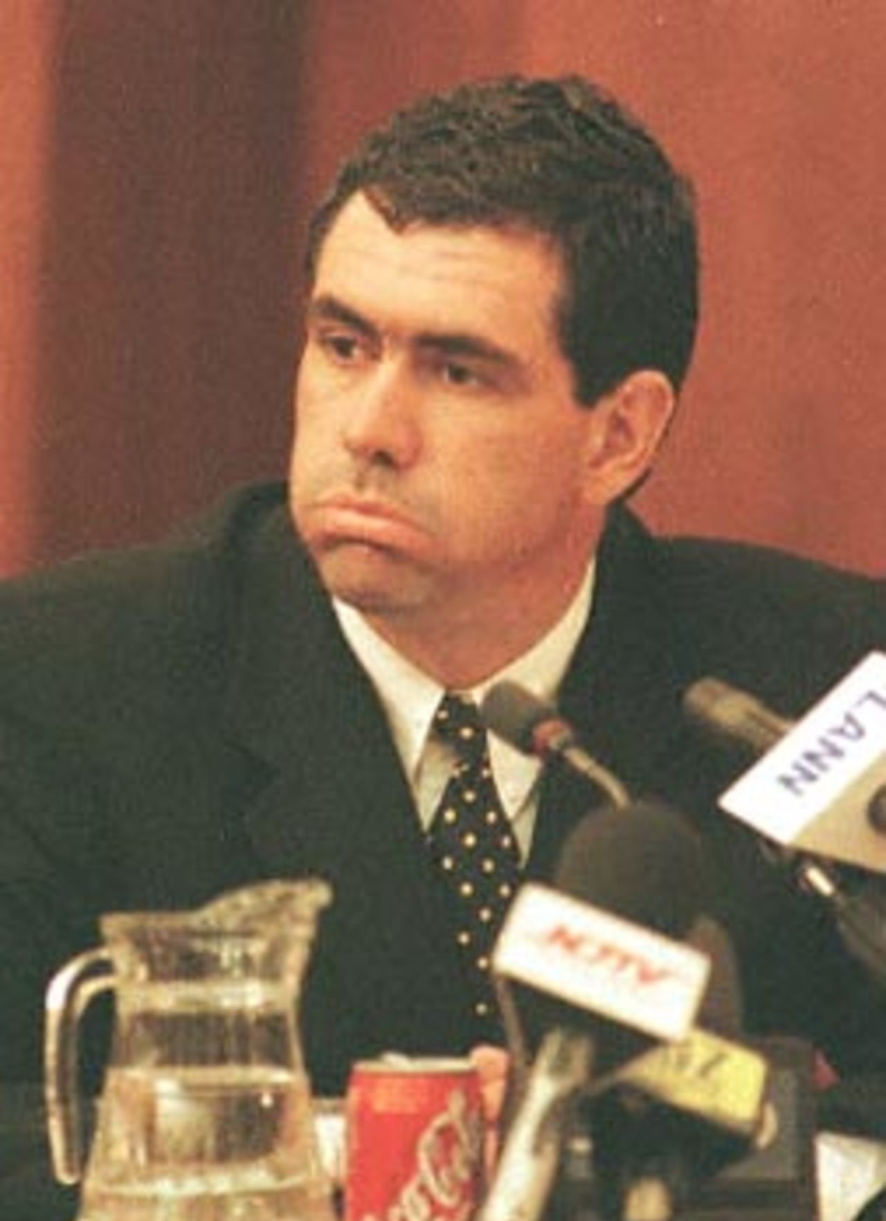 Former South African cricket captain Hansie Cronje puffs out his cheeks whilst giving his testimony at the King Commission of Inquiry into allegations of cricket match-fixing in Cape Town 21 June 2000.