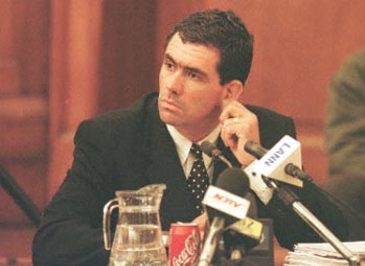 Former South African cricket captain Hansie Cronje tugs his ear during cross-examination at the King Commission of Inquiry into allegations of cricket match-fixing in Cape Town 21June 2000.