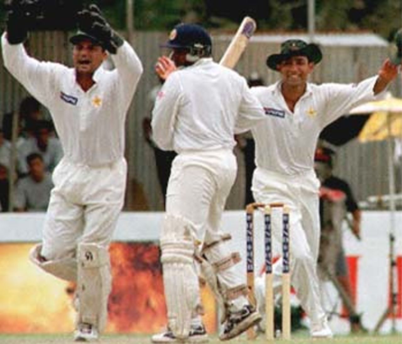 Pakistani captian Moin Khan (R) and Azhar Mahmood celebrate as Sri Lankan batsman Aravinda De Silva (C) was given out during the fourth day of the second cricket Test between Sri Lanka and Pakistan played at Galle international cricket stadium. Pakistan won the match by an innings and 163 runs to take an unbeatable 2-0 lead in the three Test series. Pakistan in Sri Lanka, 1999/00, 2nd Test, Sri Lanka v Pakistan, Galle International Stadium, 21-25 June 2000 (Day 4).