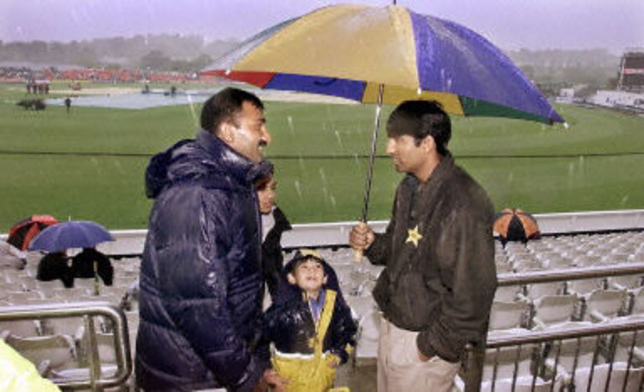 Yousuf Youhana chats to a Pakistani supporter in the driving rain, 6th ODI at Chester-le-Street, 16 June 2001.