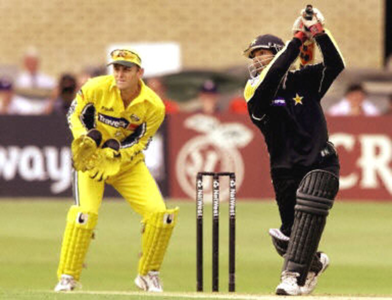 Yousuf Youhana cracks a ball over cover from Shane Warne as Adam Gilchrist looks on, 8th ODI at Trent Bridge, 19 June 2001.