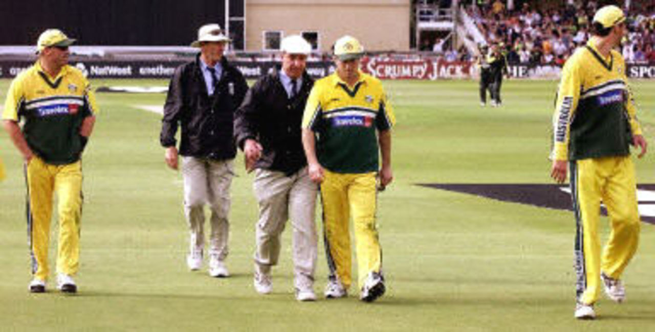Steve Waugh speaks to umpire George Sharp as he leads his team off the field, 8th ODI at Trent Bridge, 19 June 2001.