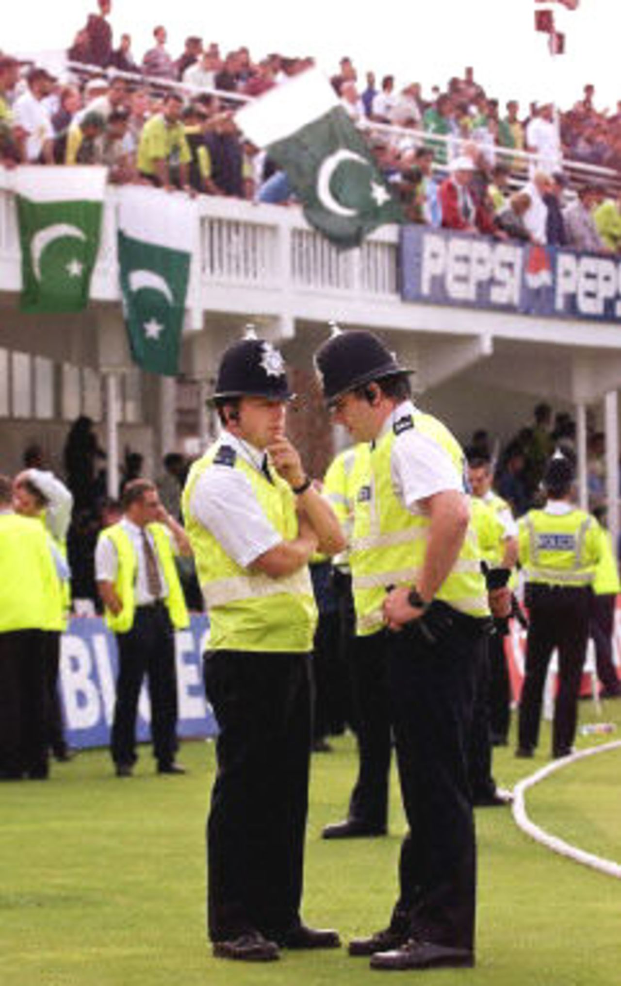 Two policemen discuss the situation after Steve Waugh led his team off the field, 8th ODI at Trent Bridge, 19 June 2001.
