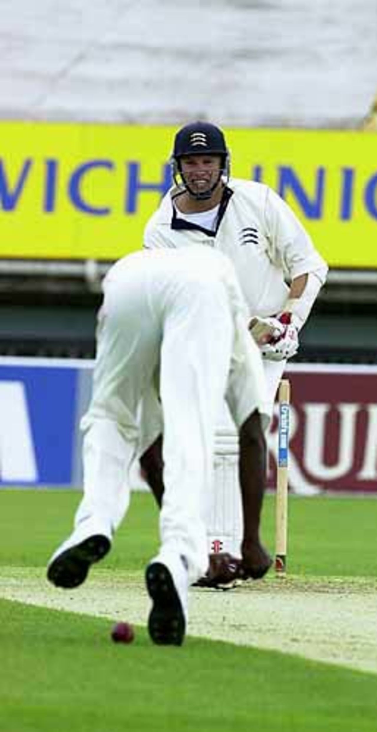 Bowler Drakes drops a caught and bowled chance off Robin Weston of Middx