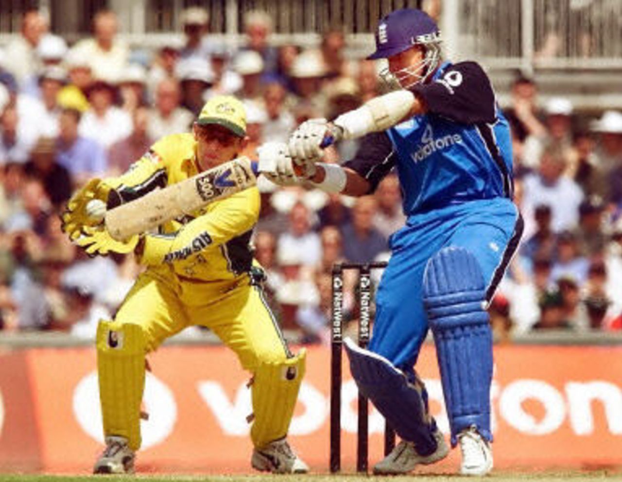 Alec Stewart hits out as Adam Gilchrist looks on, 9th ODI at the Oval, 21 June 2001.