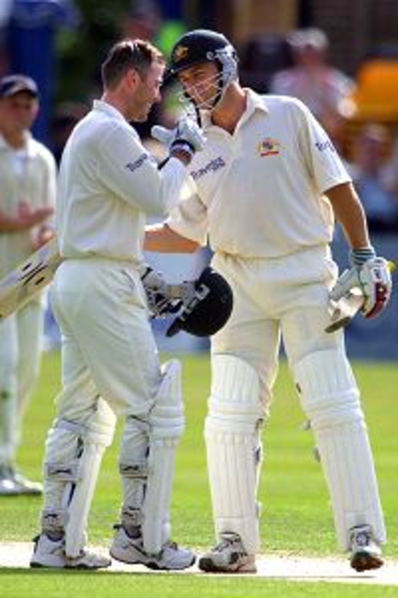 Damien Martyn of Australia [left] is congratulated by Adam Gilchrist after both players score centuries on the first day of the Vodafone Challenge match betwen Essex and Australia at the County Ground, Chelmsford.