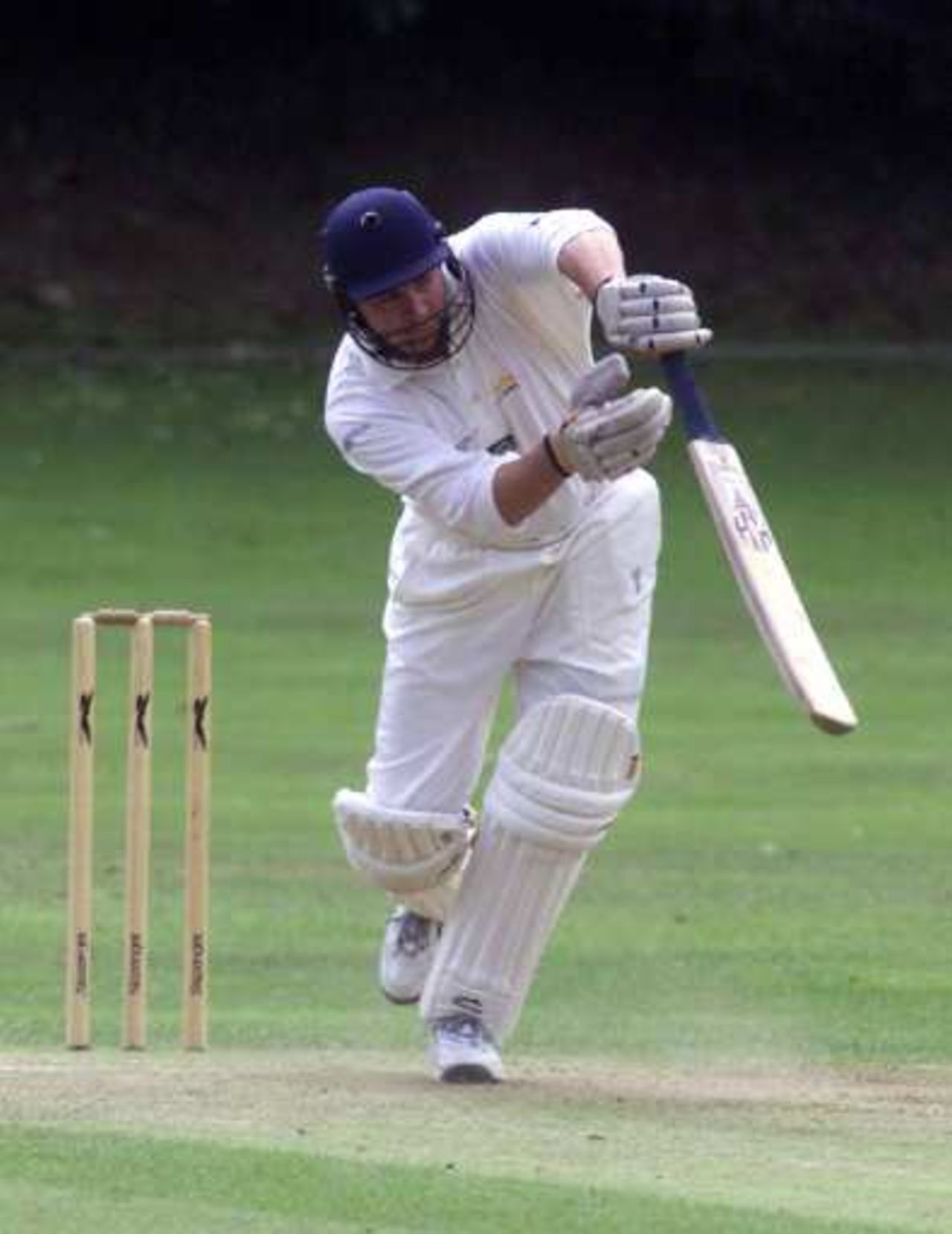 Richard Kenway of BAT CC and Hampshire Cricket Board pushes forward in his innings of 99 against Calmore CC
