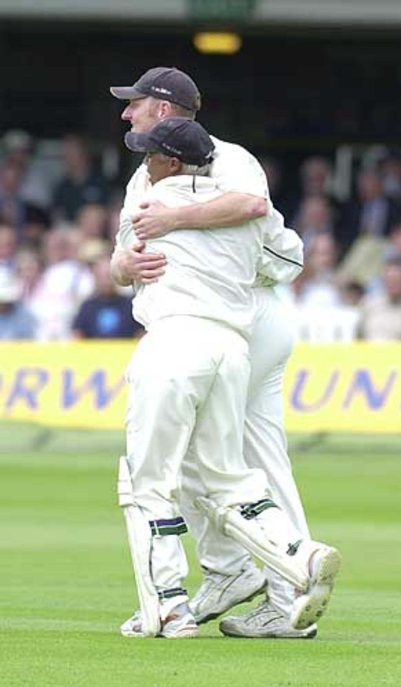 Dougie Brown gets a hug from keeper Keith Piper after he has caught out Ronnie Irani, Essex v Warwickshire, B and H Cup Final, Lord's, 22 June 2002