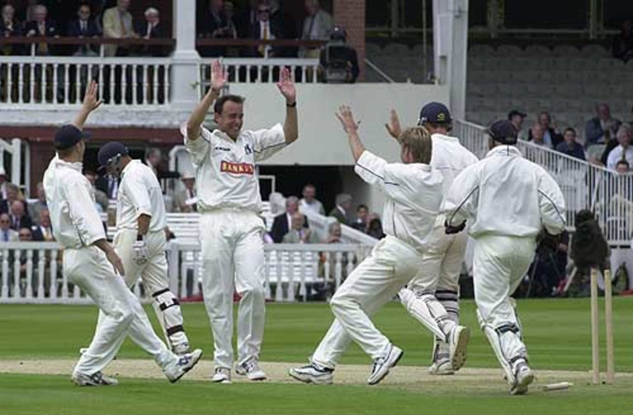 Neil Carter is the centre of attraction as he has the wicket of the departing Stephenson, Essex v Warwickshire, B and H Cup Final, Lord's, 22 July 2002