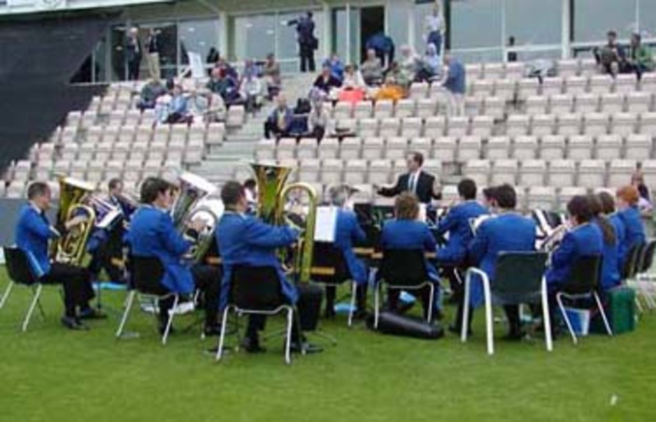The band plays on despite the drizzle before the Hawks v Lions match at The Rose Bowl