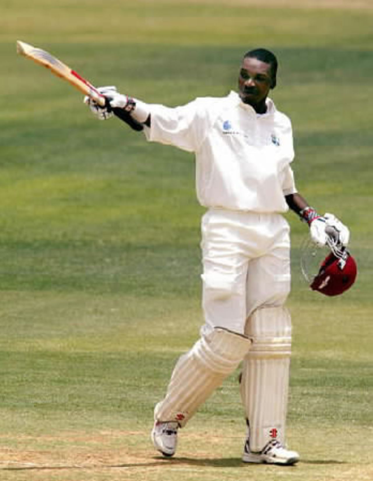 West Indies batsman Chris Gayle raises his bat to celebrate reaching his double century. Gayle went on to score 204 in his first innings. 2nd Test: West Indies v New Zealand at Queen's Park, St George's, Grenada, 28 June-2 July 2002 (30 June 2002).