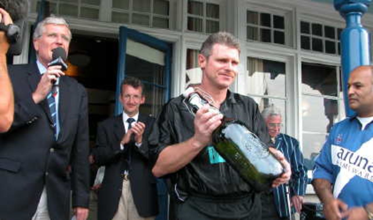 Robin Smith walks off with giant bottle of Grolsch lager