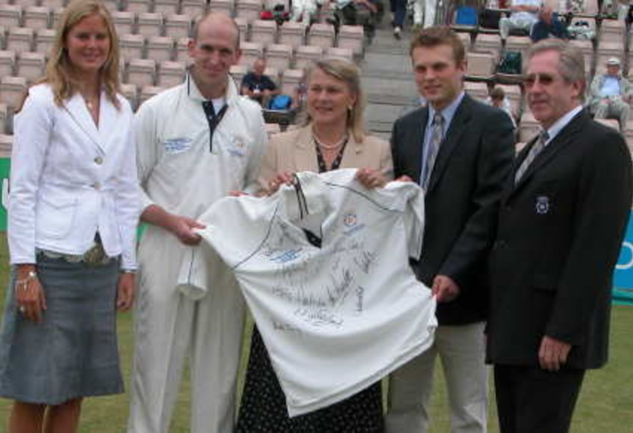 Mrs.Susan Feguson wife of the late Major Ron Ferguson flanked by her children, received a signed Hampshire shirt from captain John Crawley and chairman Rod Bransgrove.