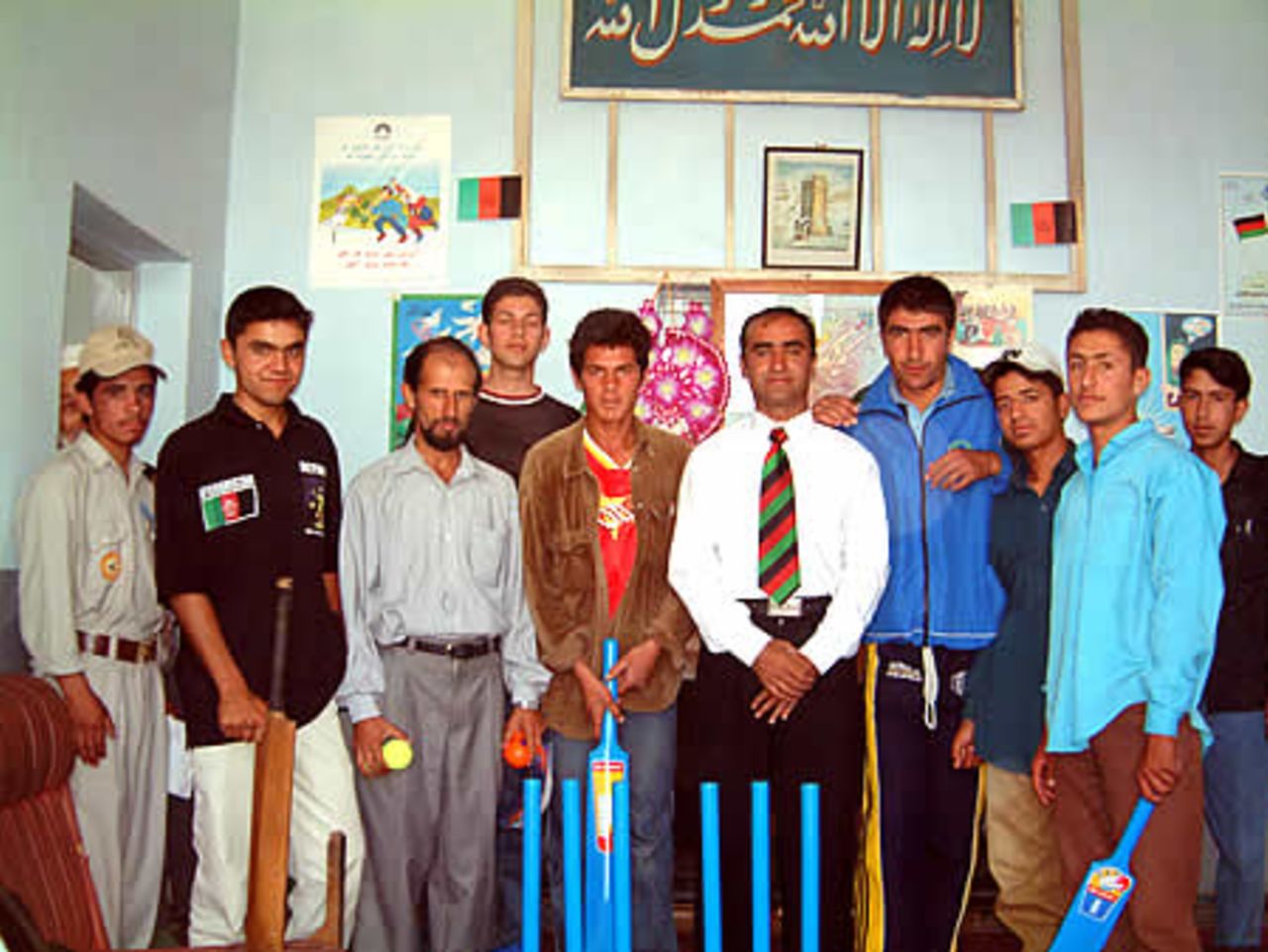 Khushal Khan High School sports teachers and students with Taj Malik Afghan National coach (white shirt and tie), Abdul Khalil (black shirt) ACF GM and Khalik Dad Noori (blue shirt) receiving Kwik cricket set donated by ECB.