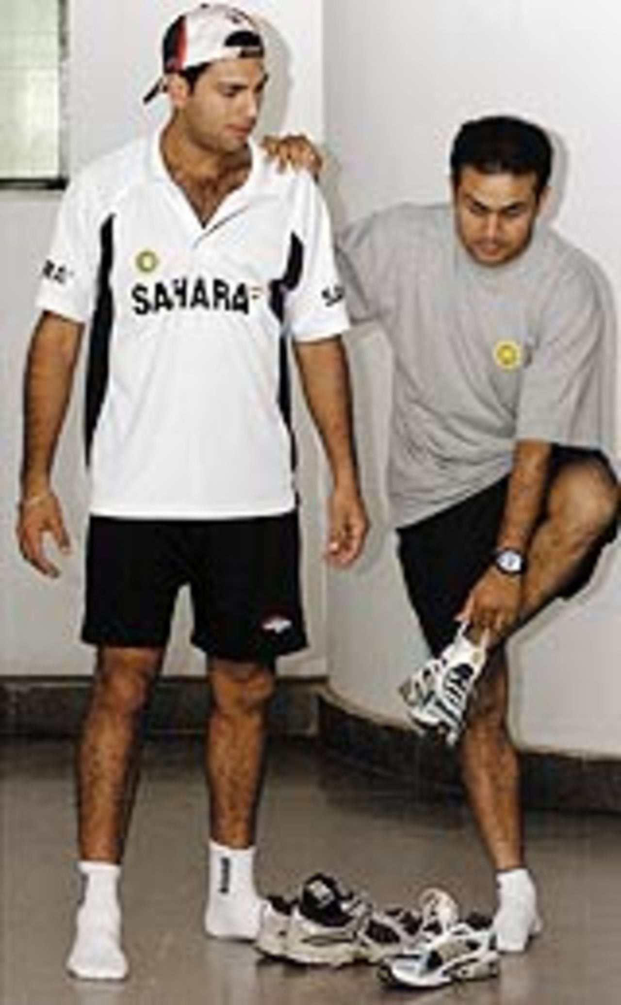 Virender Sehwag leans on Yuvraj Singh, June 13, 2004