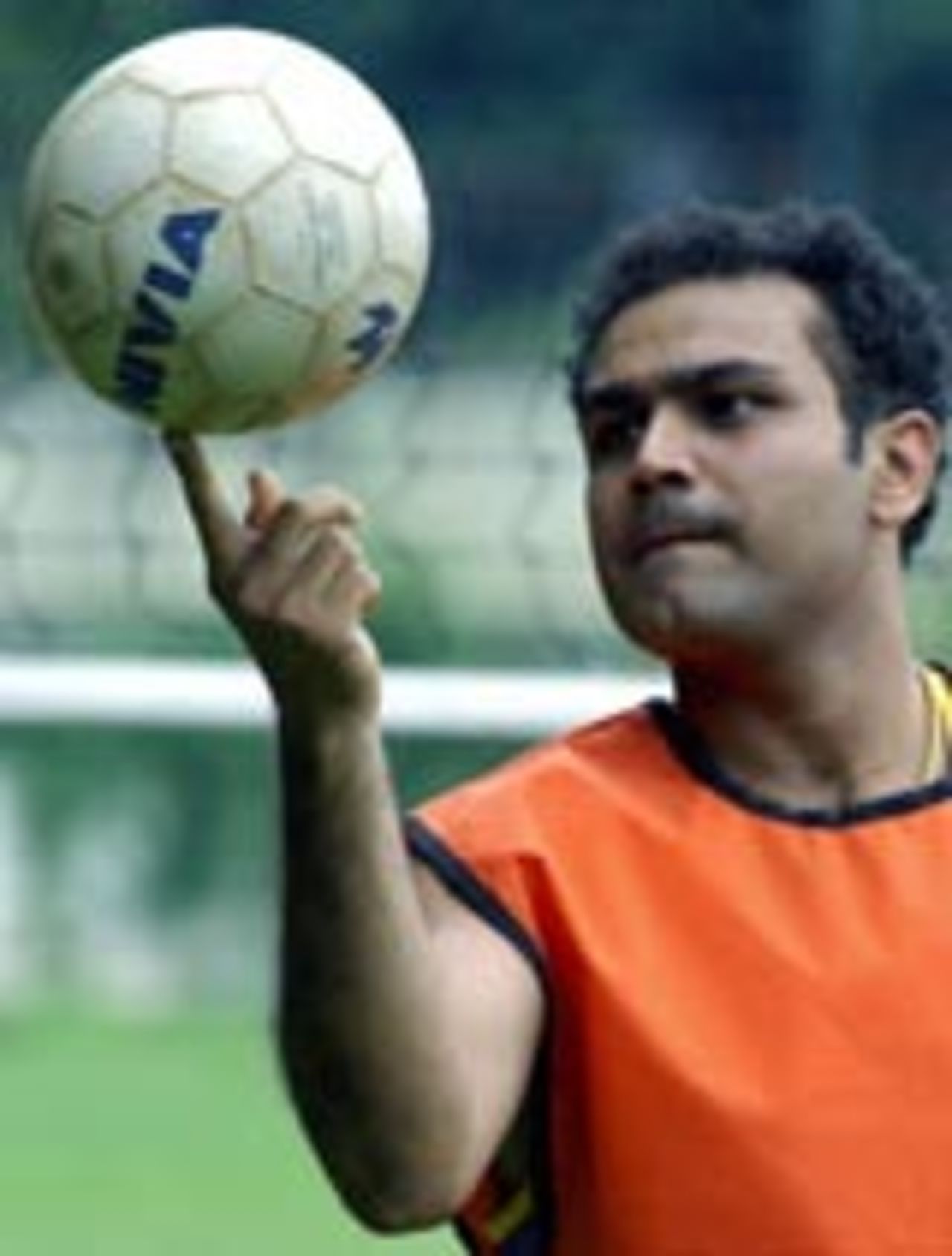 Virender Sehwag balances a volley ball during the training camp in Bangalore, June 15, 2004