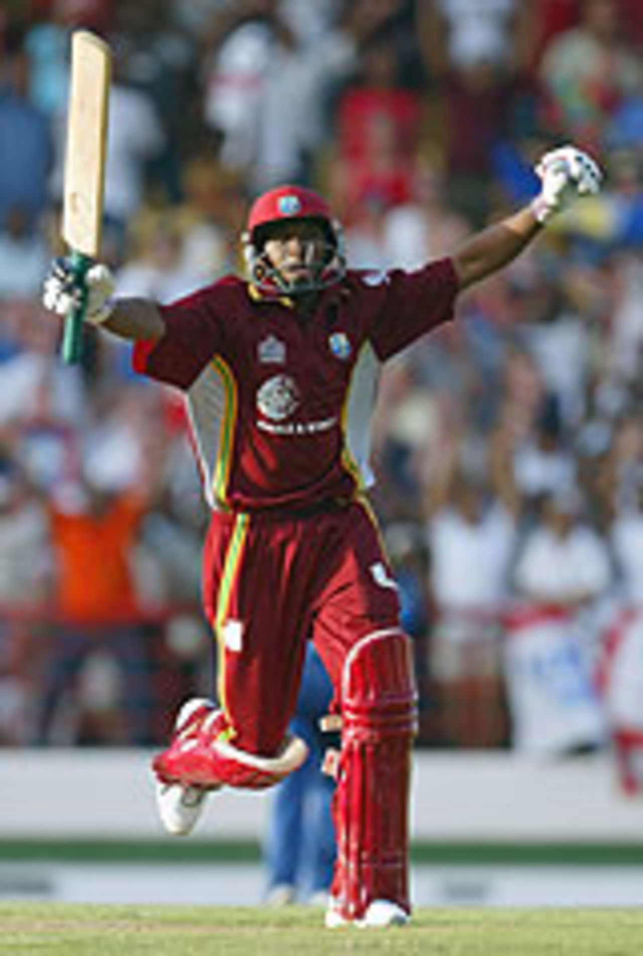 Dwayne Bravo raises his arms after winning a game for West Indies