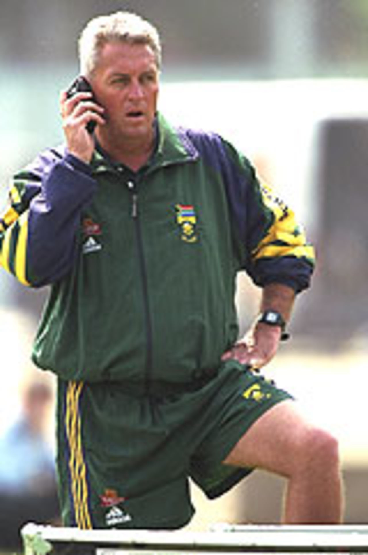 Bob Woolmer chats into his cell phone