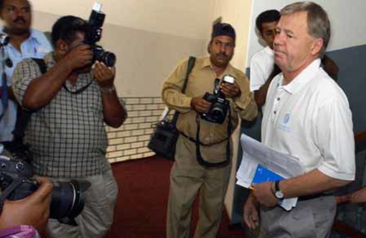 International Cricket Council (ICC) match referee Mike Procter (R) arrives to face the media in Multan