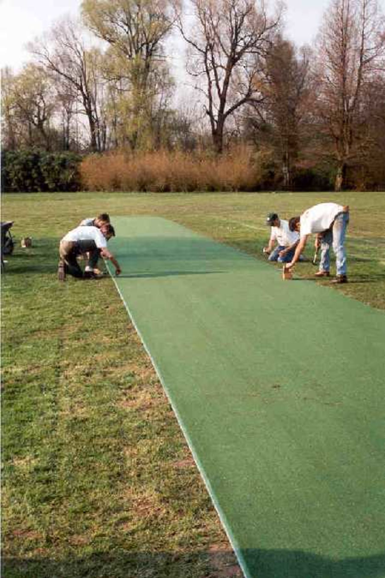 The Belgium Cricket Federation staff lay an artificial pitch at Mechelen - Final touches