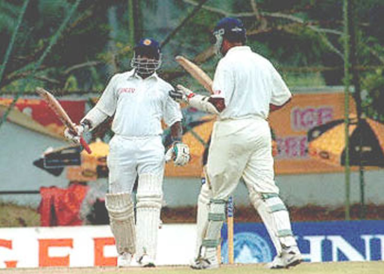 Sri Lankan batsman Sanath Jayasuriya (L) and Marvan Atapattu celebrate after Jayasuriya reached 100 runs during the second day of the third cricket test against Pakistan. Jayasuriya was unbeaten on 148, Attapatu was at 107 at the the lunch break as Sri Lanka scored 267 runs without loosing any wickets. Pakistan in Sri Lanka, 1999/00, 3rd Test, Sri Lanka v Pakistan, Asgiriya Stadium, Kandy, 28Jun-02Jul 2000 (Day 2).