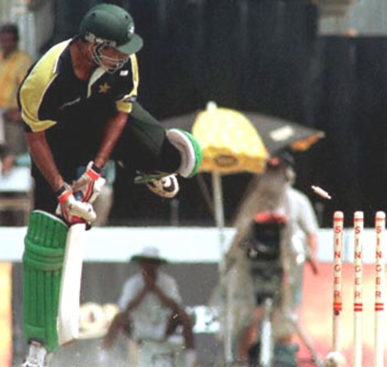 Pakistani batsman Waqar Younis looks back as his stumps are shattered by Sri Lankan bowler Nuwan Zoysa during the first Singer Triangular ODI match in Galle, Sri Lanka 05 July 2000. Pakistan made 164 runs for eight wickets in 45 overs.