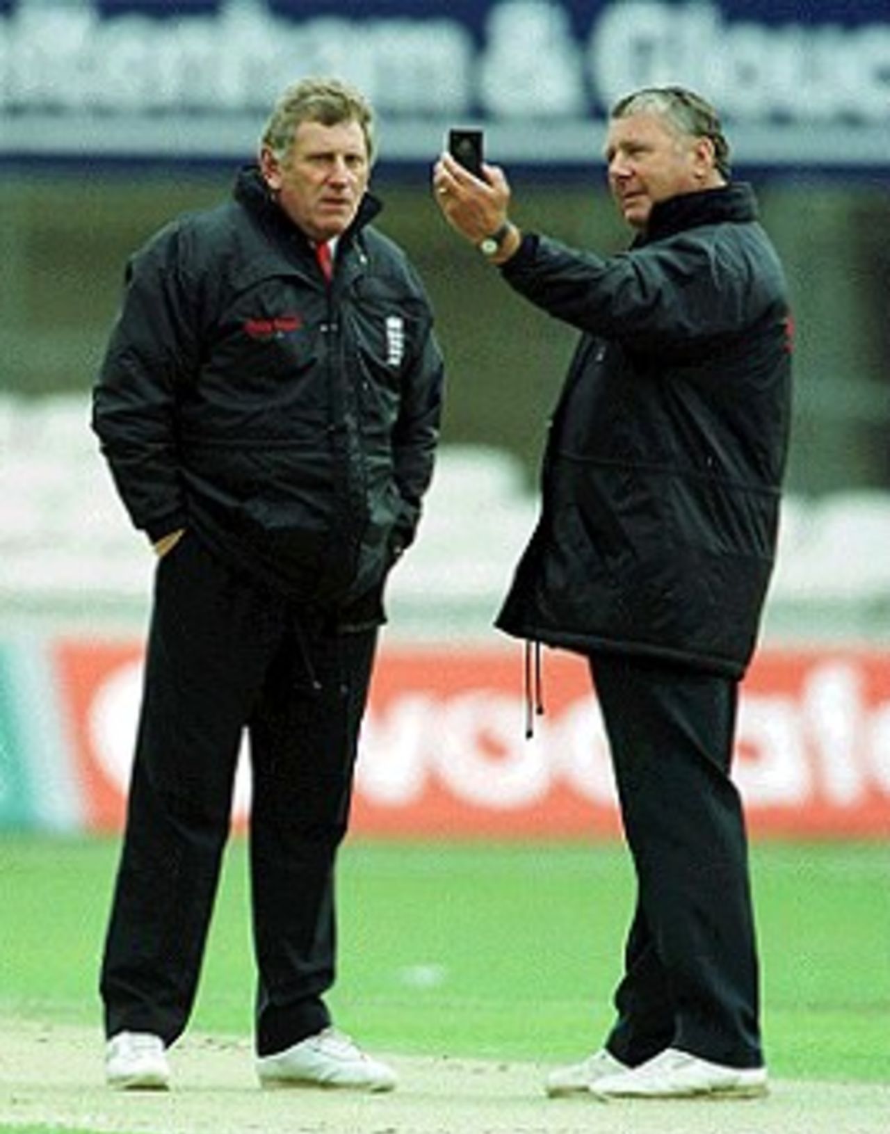 5 July 2000. Umpires Mike Harris [right] and Graham Burgess check the light during the Natwest fourth round match between Surrey and Sussex at the Oval in London.