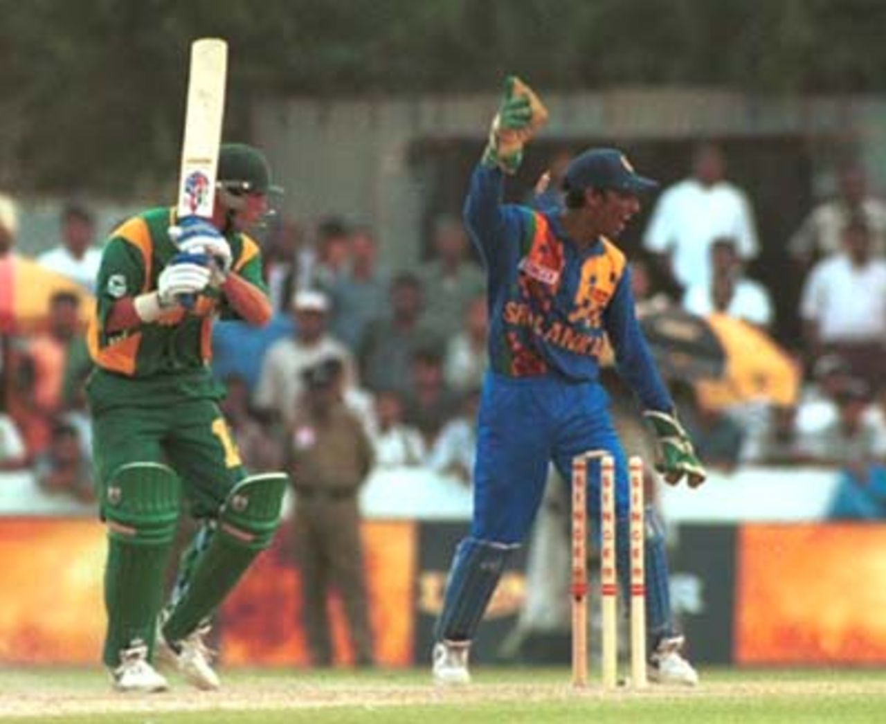 Sri Lankan wicket keeper Kumar Sangakkara celebrates as a delivery from Sri Lankan bowler Muthiah Murlitharan clean bowls the South African batsman Nicky Boje during the Singer Cup Triangular limited overs cricket match between Sri Lanka and South Africa in Galle International stadium in Galle Sri Lanka on Thursday, July. 6, 2000
