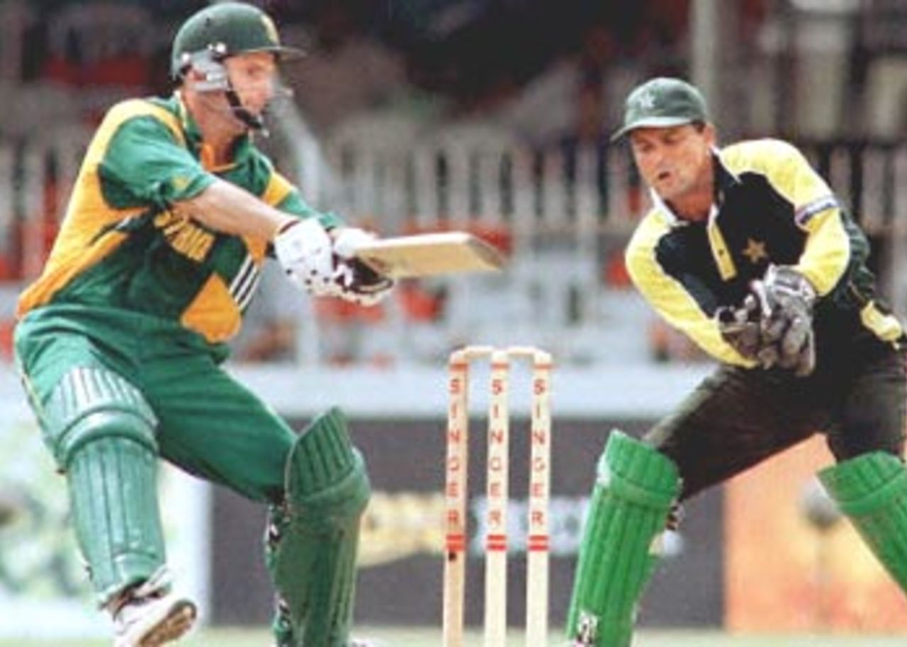 South African batsman Gary Kirsten is seen in action against Pakistan in the Singer Triangular series in the Sri Lankan capital of Colombo. South Africa won the match by seven wickets. Pakistan captain and wicketkeeper Moin Khan is seen at right. Singer Triangular Series, 2000/01, 6th Match, Pakistan v South Africa, Sinhalese Sports Club Ground, Colombo, 12 July 2000.