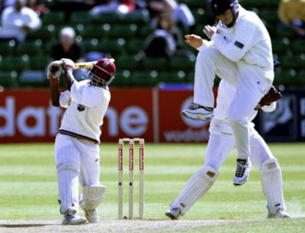 6 Jun 2000: Mahendra Nagamootoo batting for the West Indies with Mike Powell of Glamorgan in the air during the Vodafone Series Match between Glamorgan v West Indies played at Sophia Gardens in Cardiff.