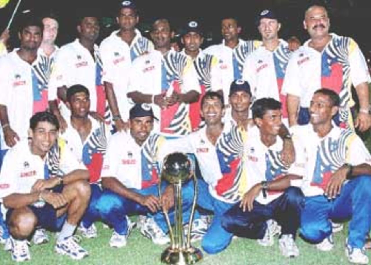 The Sri Lankan cricket team poses with the Singer Cup in Colombo. Hosts Sri Lanka unleashed their batting might to overwhelm South Africa by 30 runs in the Singer Cup one-day final. Singer Triangular Series, 2000/01, Final, Sri Lanka v South Africa, R.Premadasa Stadium, Khettarama, Colombo, 14 July 2000.