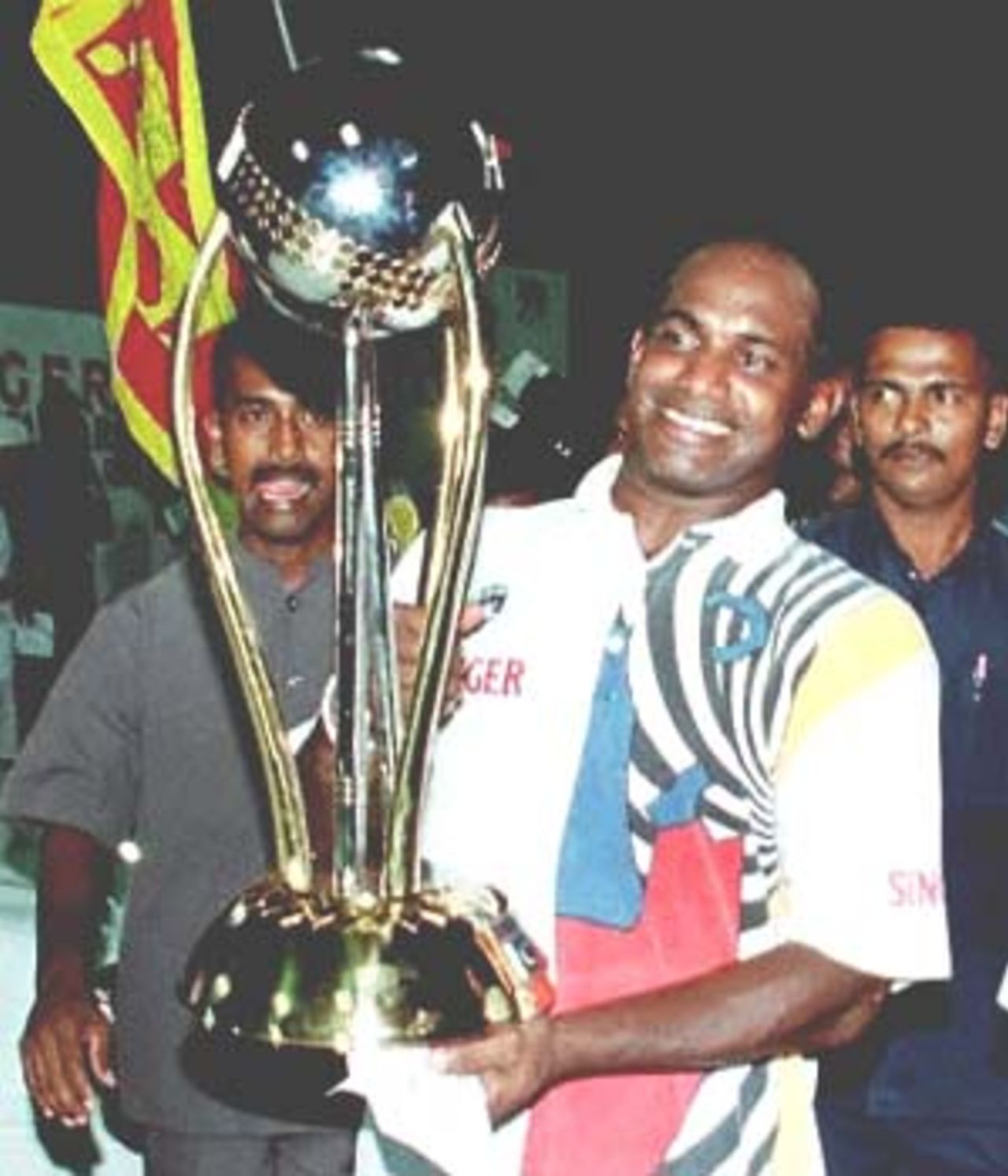 Sri Lankan skipper Sanath Jayasuriya carries the Singer Cup in Colombo. Hosts Sri Lanka unleashed their batting might to overwhelm South Africa by 30 runs in the Singer Cup one-day final. Singer Triangular Series, 2000/01, Final, Sri Lanka v South Africa, R.Premadasa Stadium, Khettarama, Colombo, 14 July 2000.