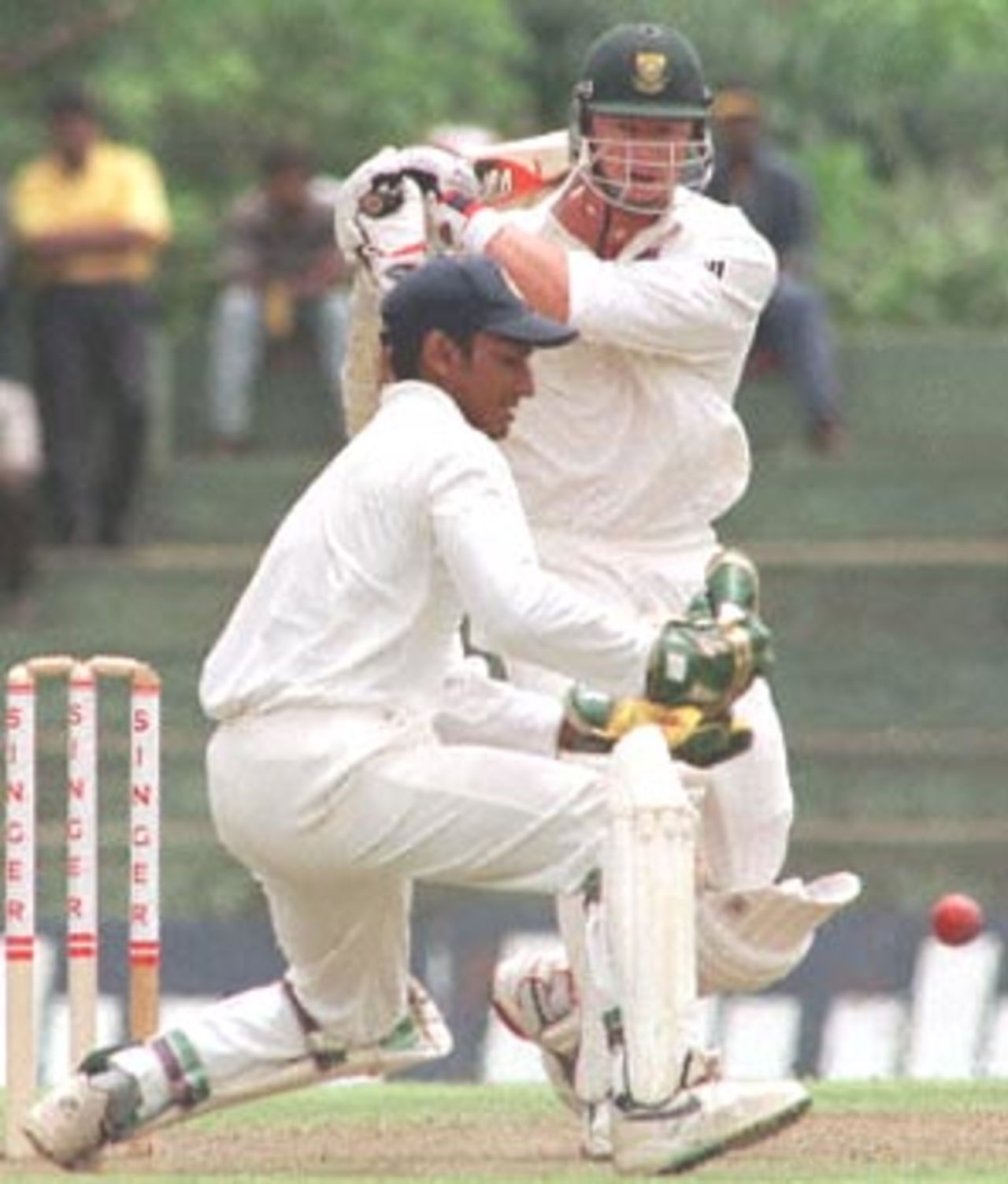 Sri Lankan wicketkeeper Kumar Sangakkara (L) attempts to hold the ball as South African batsman Lance Klusener looks on. South Africa in Sri Lanka 2000/01, 2nd Test, Sri Lanka v South Africa Asgiriya Stadium, Kandy, 30 July-03 August 2000 (Day 1)