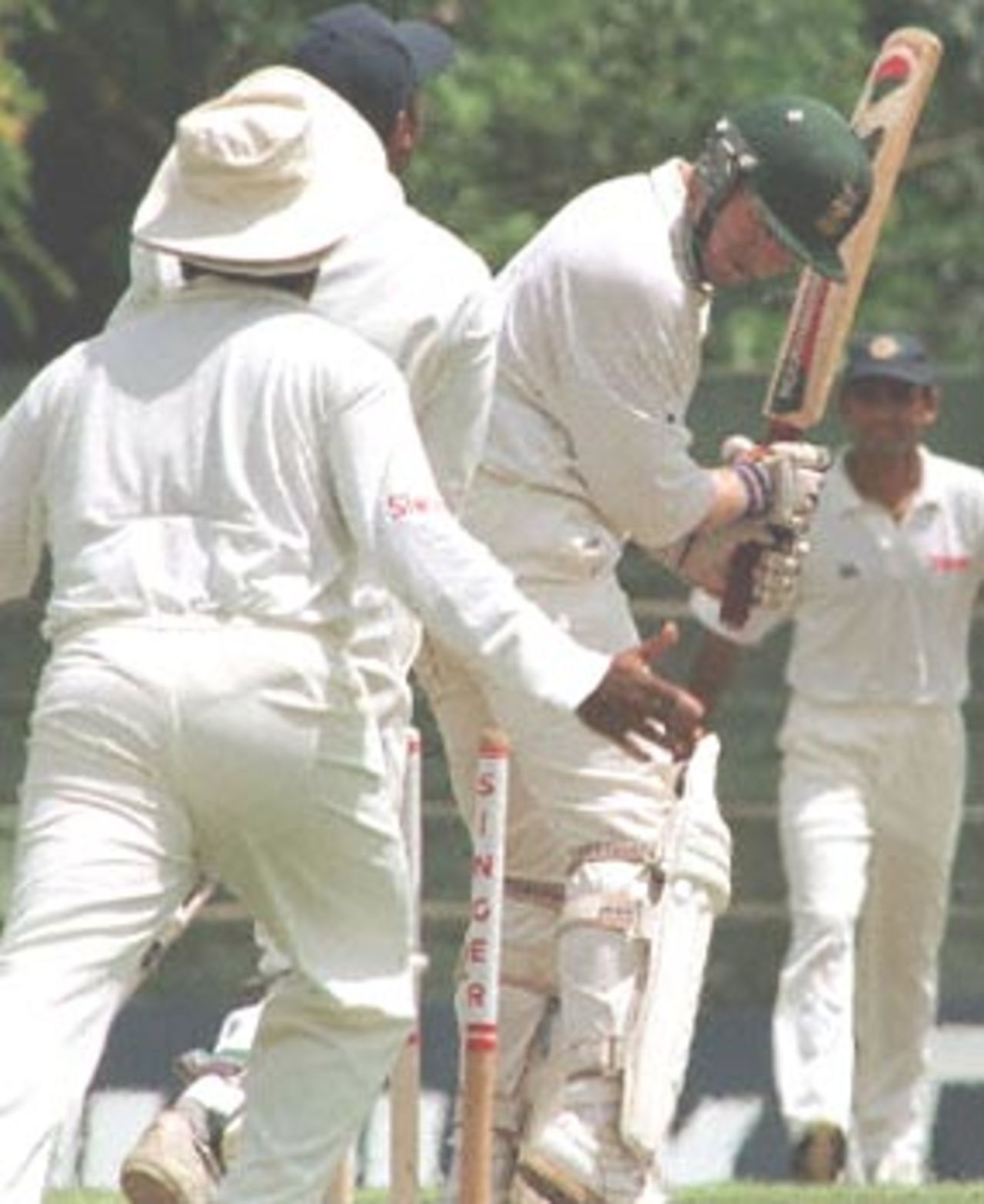 South African batsman Daryll Cullinan (2nd R) looks back to see a ball from Sri Lankan bowler Kumar Dharmasena (R) hit his stumps during the first day of the second test cricket match between Sri lanka and South Africa at the Asgiriya International Stadium in Kandy, Sri Lanka 30 July 2000. South Africa made 253 runs for the first innings. Klusener and Mark Boucher hit half-centuries apiece to save South Africa from total collapse on the opening day of the Test.