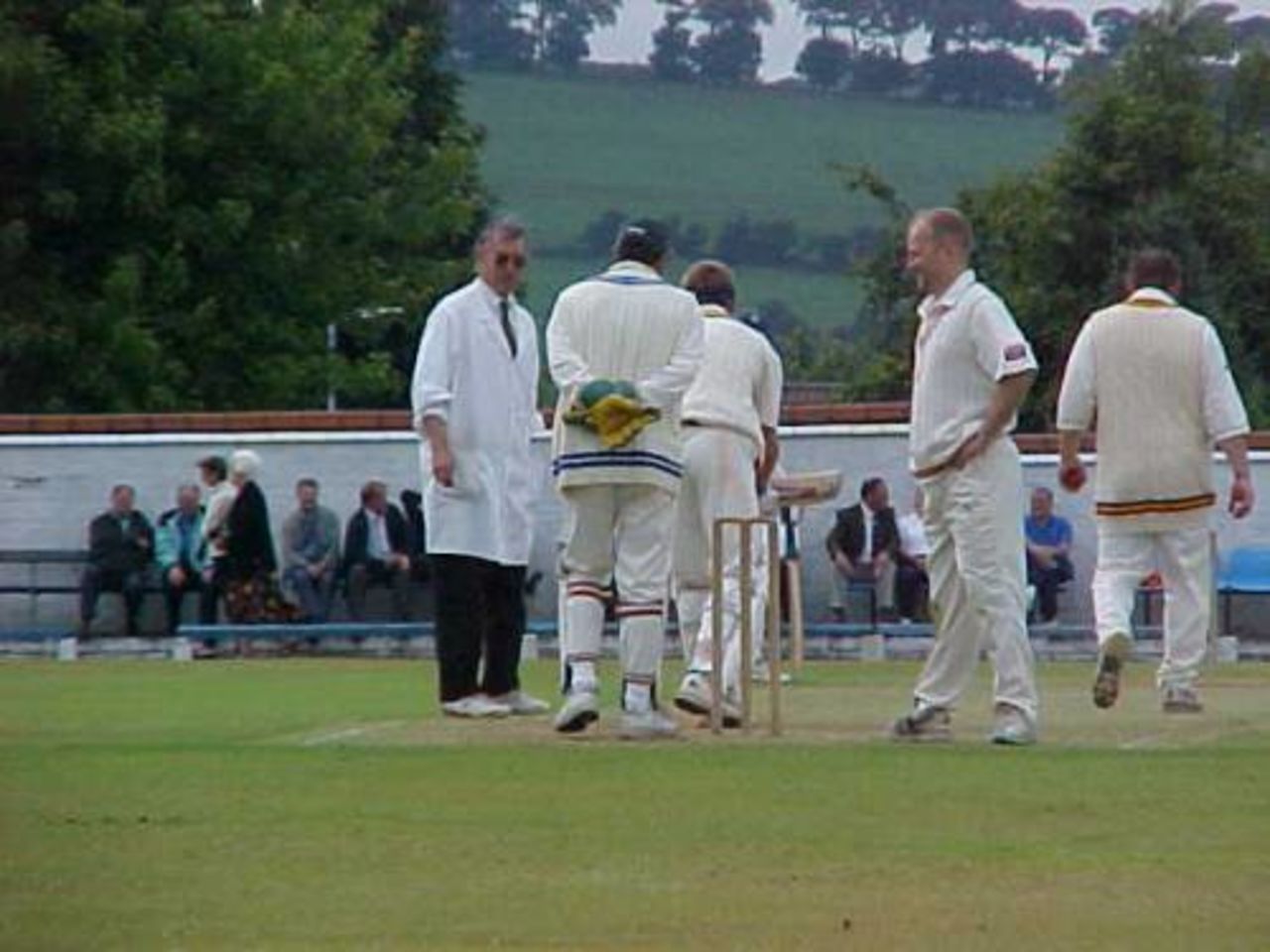 Rishton wicketkeeper Graham Lightbown recovers from a blow in the face